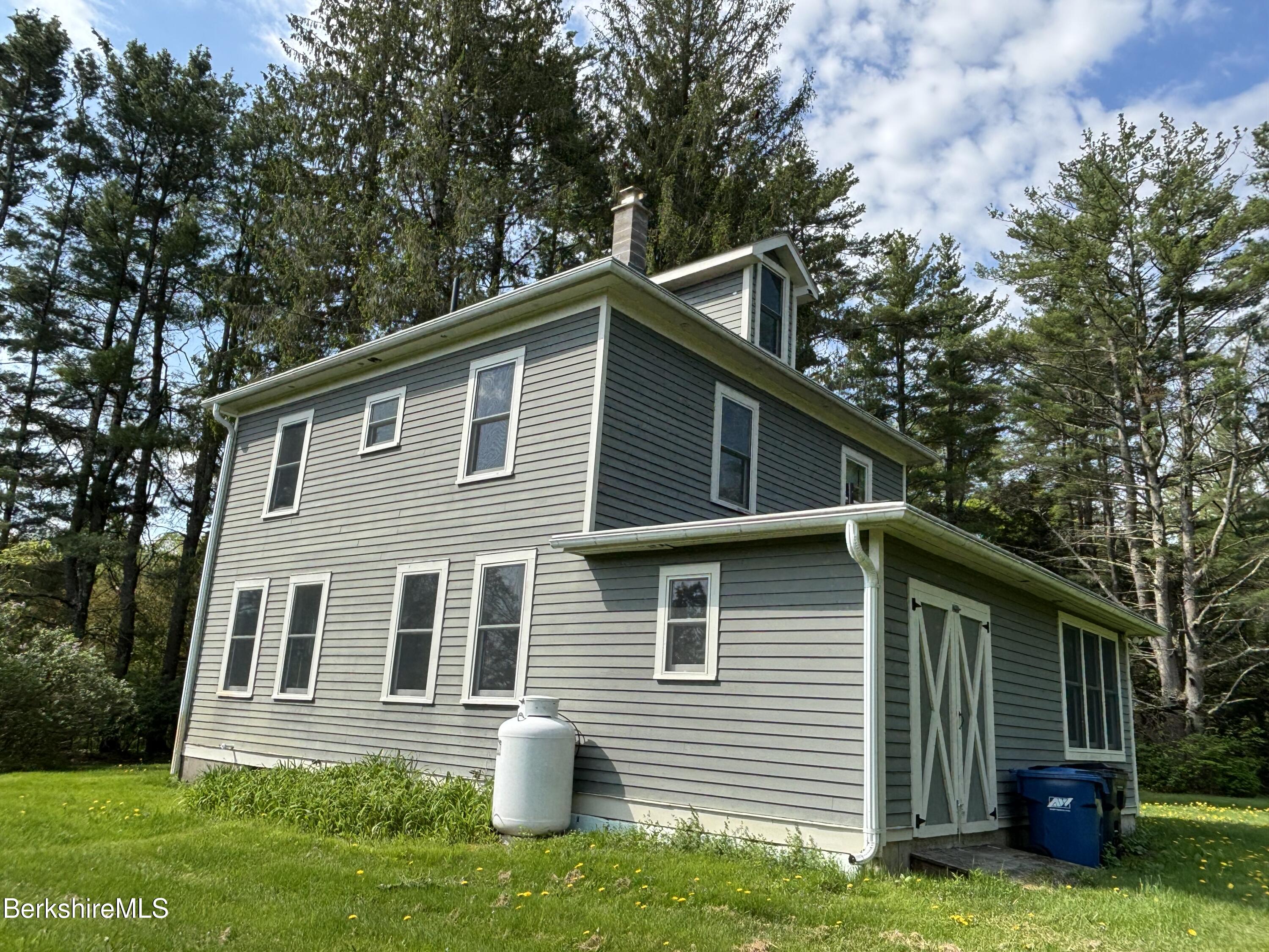 86 Miner Road Lanesborough, MA 01237 - Photo 2 of 44 a front view of house with yard and green space