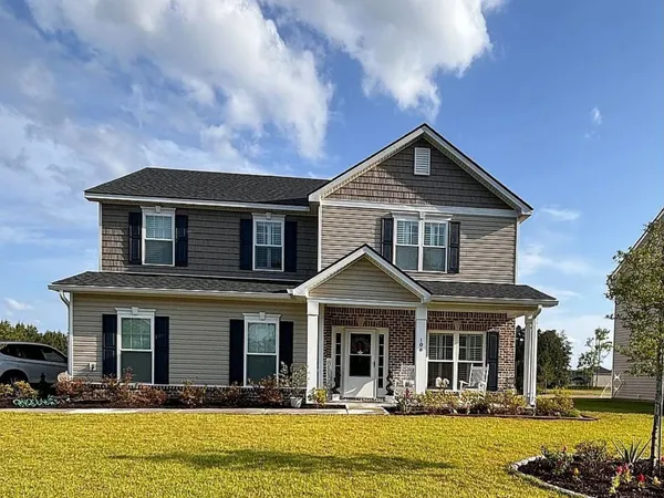 a front view of a house with swimming pool and porch