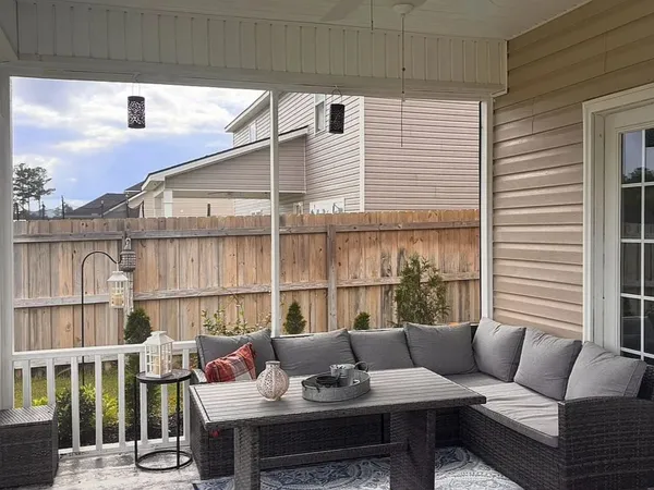 a balcony with furniture and a potted plant
