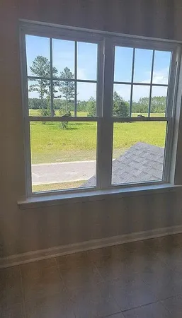 a view of a large window with a yard