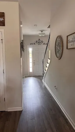 a view of a hallway with wooden floor