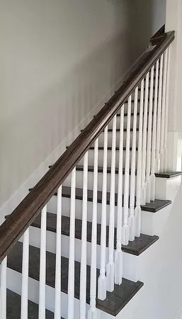 a view of staircase with wooden floor