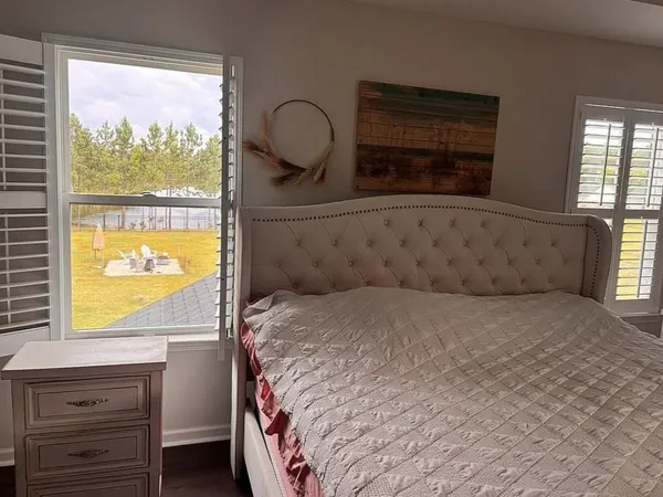 a bedroom with a bed and a window