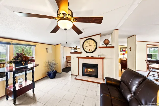 a living room with furniture a clock and a fireplace