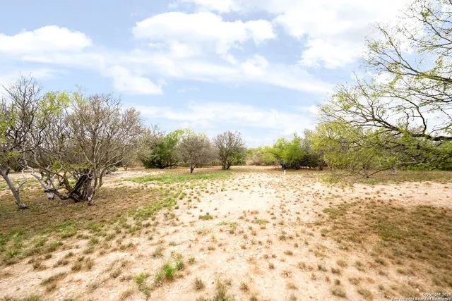 a view of a yard with snow on the road