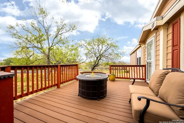 a view of balcony with wooden floor and seating space