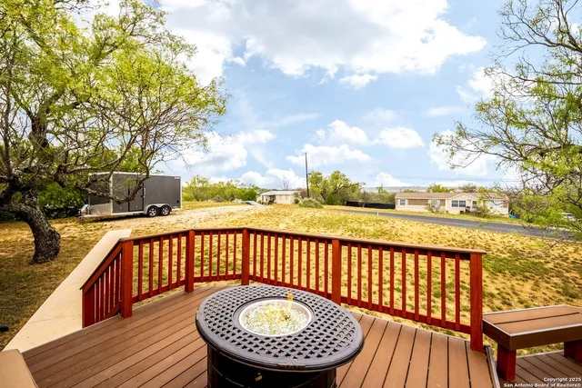 a view of a roof deck with wooden floor and fence
