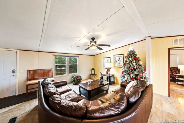 a living room with furniture gym equipment and a large window