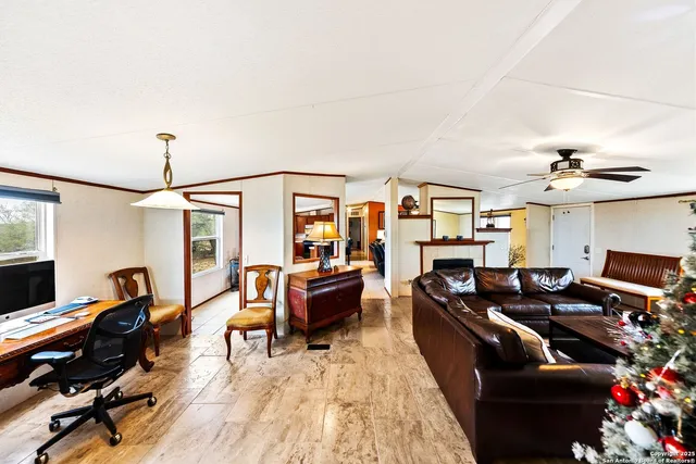 a living room with furniture and wooden floor