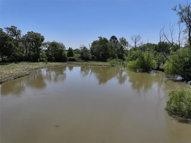 a view of a lake in middle of forest