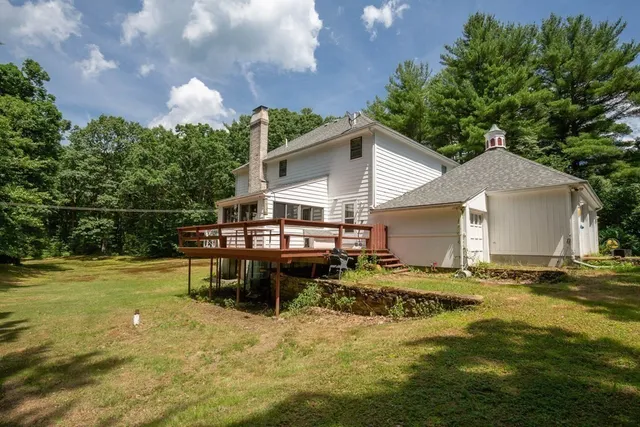 a view of a house with backyard and sitting area