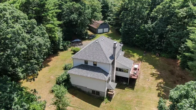 an aerial view of a house with a yard
