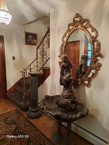 a view of a dining room with furniture a chandelier and wooden floor