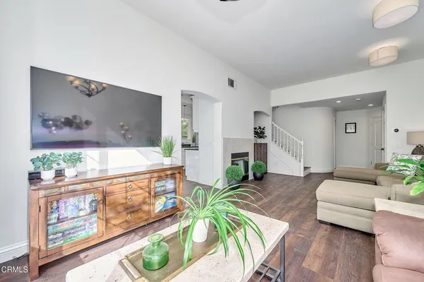 a living room with furniture a chandelier and a large window