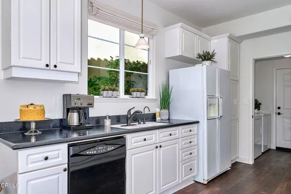 a kitchen with stainless steel appliances granite countertop white cabinets and a granite counter tops