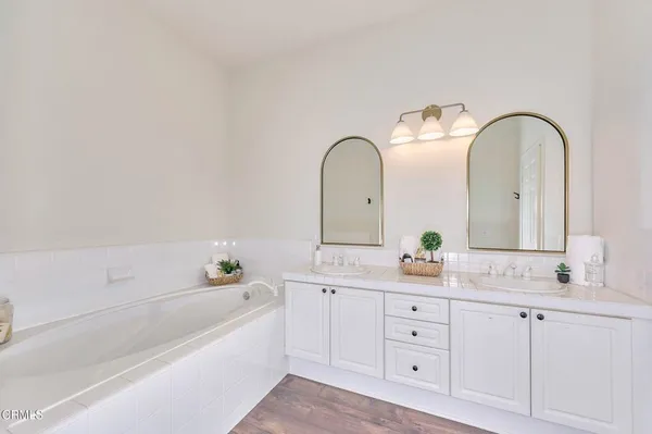 a spacious bathroom with a double vanity sink and a mirror