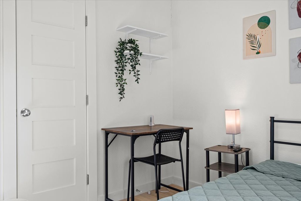 1406 North Georgetown Street Round Rock, TX 78664 - Photo 7 of 34 Well-lit sleeping quarters with bright white walls and a charming corner desk setup.