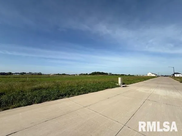 a view of a pathway both side of grassy field with grassy field