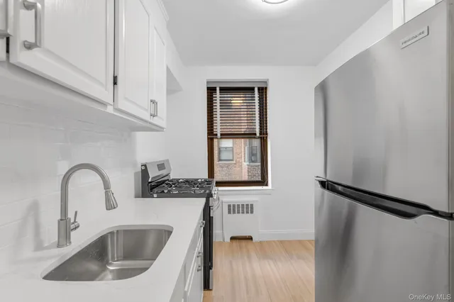 a kitchen with a sink a refrigerator and window