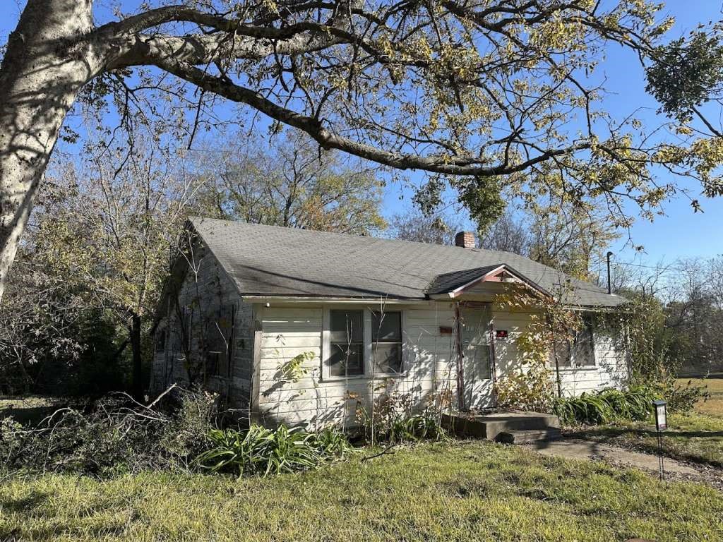 1121 Norris Street Commerce, TX 75428 - Photo 1 of 3 a front view of a house with garden