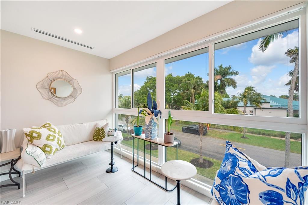 1021 3rd Street South, Unit 310 Naples, FL 34102 - Photo 8 of 20 a living room with furniture and a large window