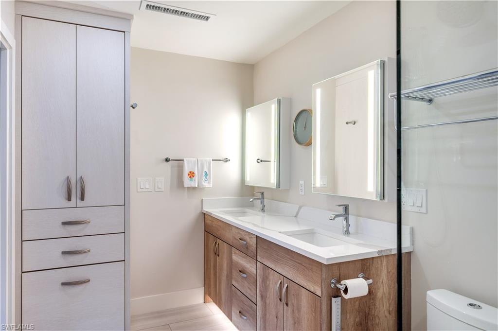 1021 3rd Street South, Unit 310 Naples, FL 34102 - Photo 13 of 20 a bathroom with a sink and a mirror