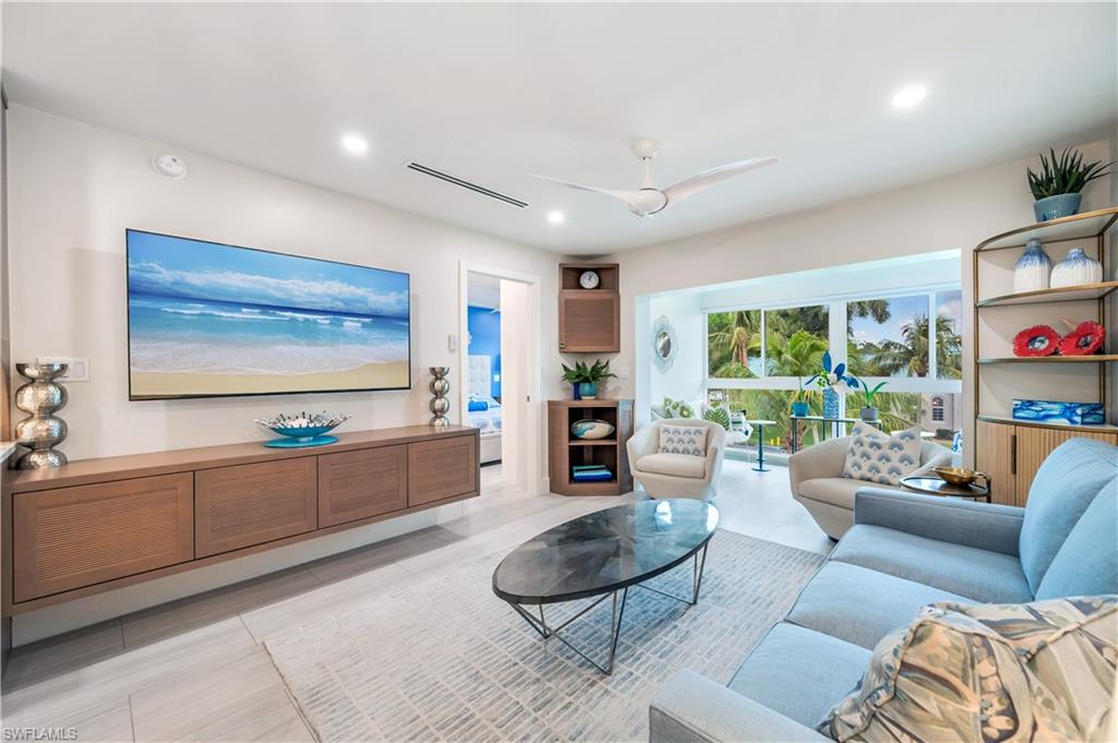 1021 3rd Street South, Unit 310 Naples, FL 34102 - Photo 6 of 20 a living room with furniture and a flat screen tv