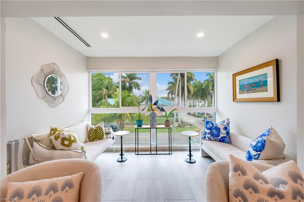 1021 3rd Street South, Unit 310 Naples, FL 34102 - Photo 7 of 20 a living room with furniture and a large window
