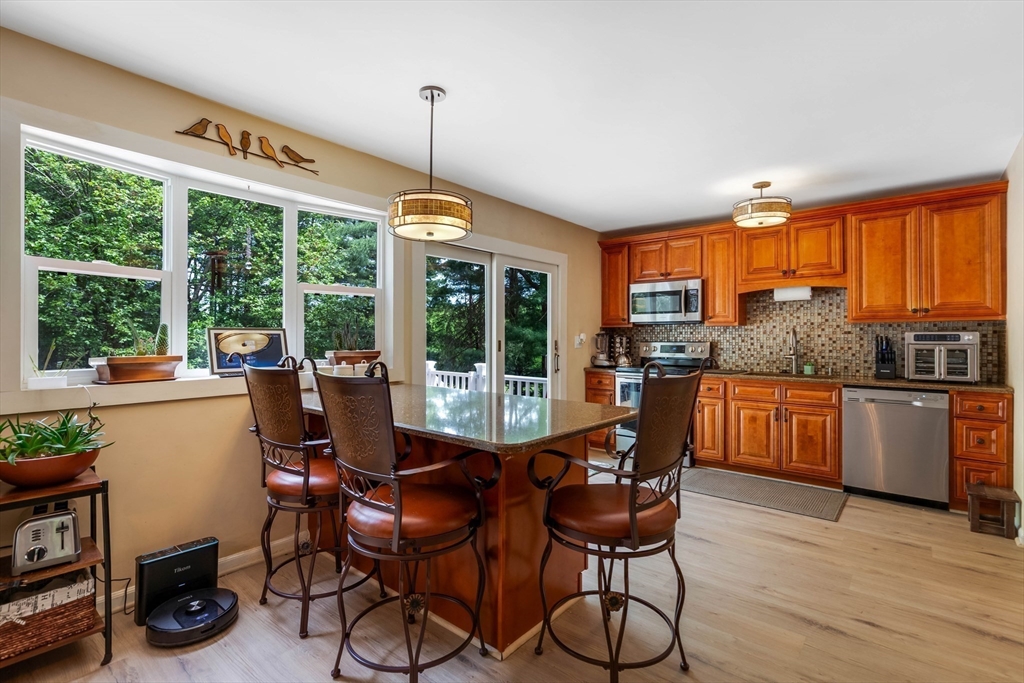 15 Conestoga Road Lexington, MA 02421 - Photo 10 of 31 a dining room with furniture a chandelier and wooden floor