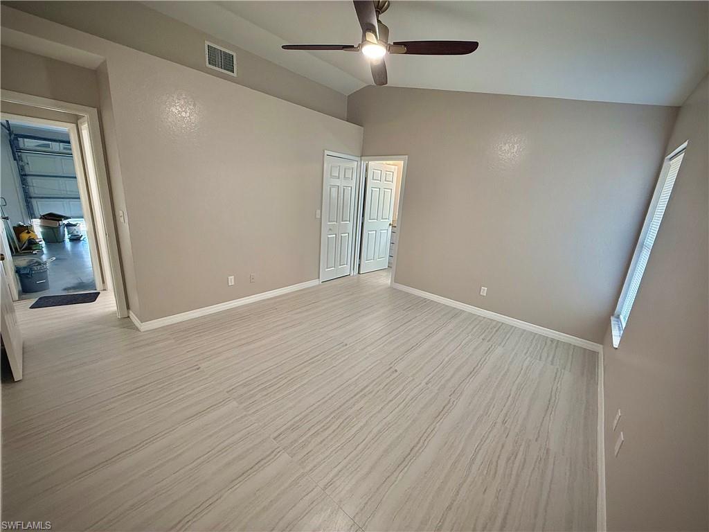 241 8th Street Southeast Naples, FL 34117 - Photo 13 of 50 an empty room with wooden floor and entrance