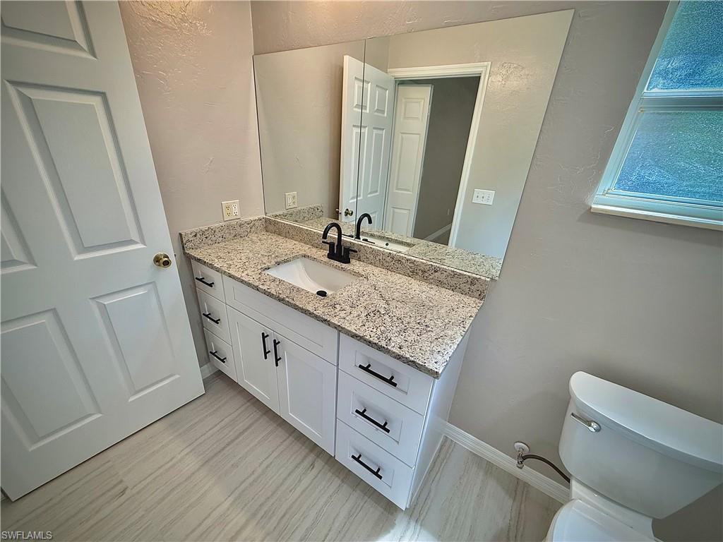 241 8th Street Southeast Naples, FL 34117 - Photo 18 of 50 a bathroom with a granite countertop sink and a mirror