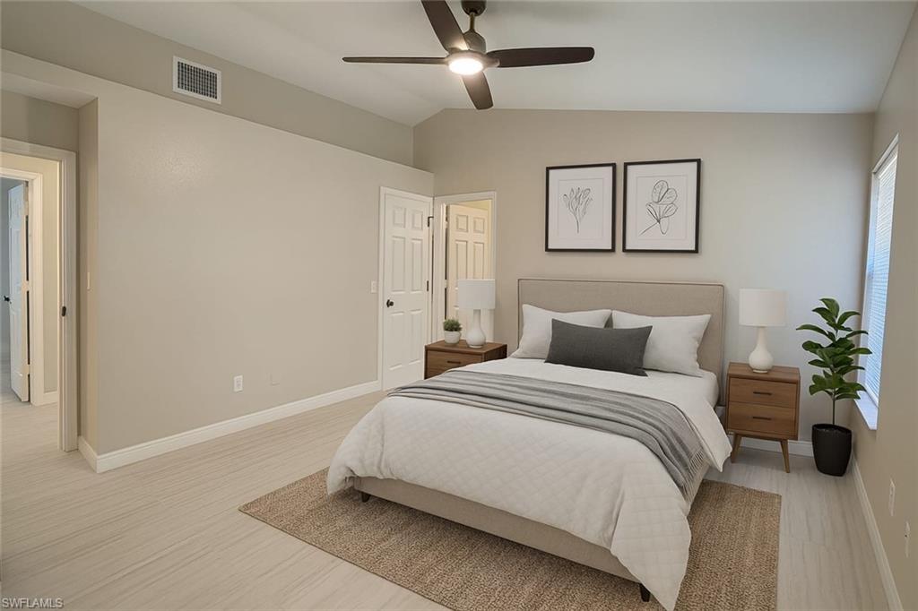 241 8th Street Southeast Naples, FL 34117 - Photo 31 of 50 a bedroom with bed and a potted plant