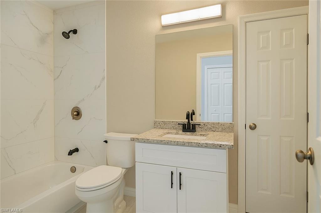 241 8th Street Southeast Naples, FL 34117 - Photo 38 of 50 a bathroom with a granite countertop sink toilet and shower