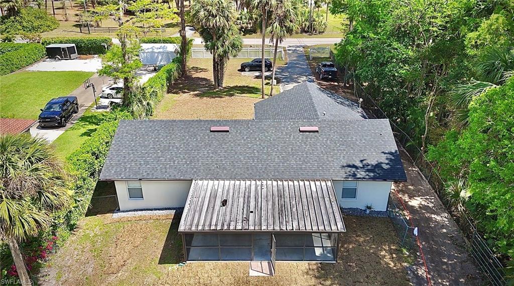 241 8th Street Southeast Naples, FL 34117 - Photo 46 of 50 an aerial view of a house with swimming pool and large trees