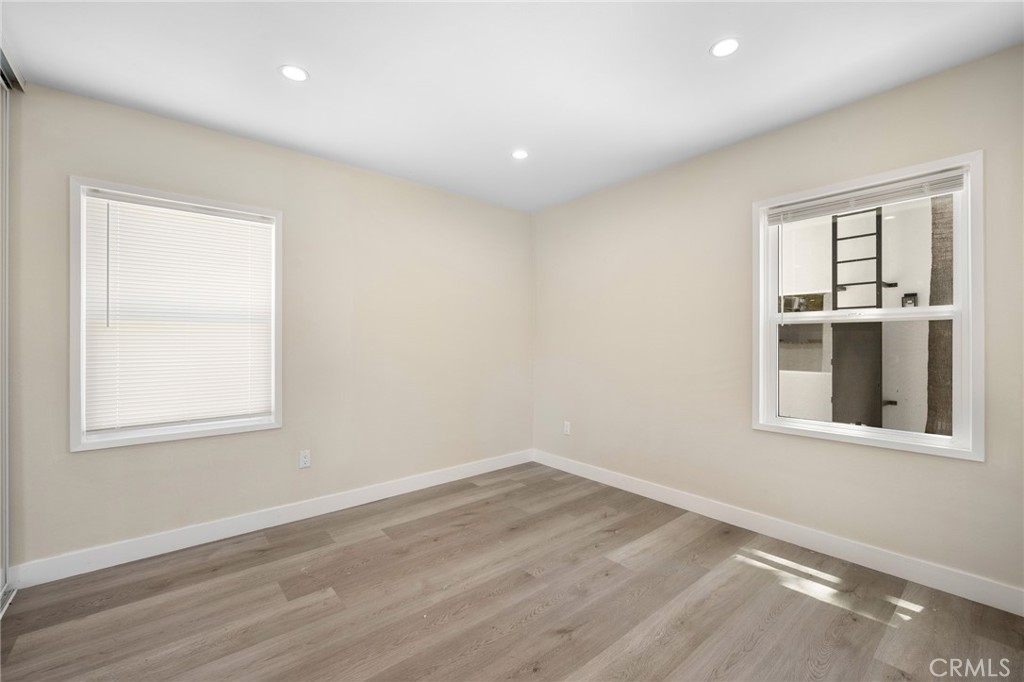 8435 Rincon Avenue Sun Valley, CA 91352 - Photo 13 of 61 an empty room with wooden floor and windows