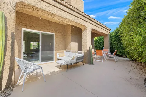 a view of a patio with a table and chairs
