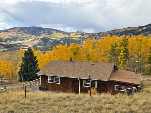 a view of a house with a yard and mountain