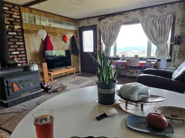 a living room with furniture a window and a flat screen tv