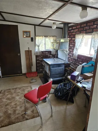 a living room with furniture a rug and a window
