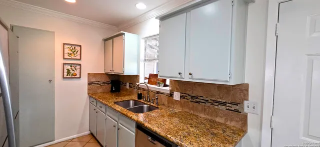 a kitchen with a sink and cabinets