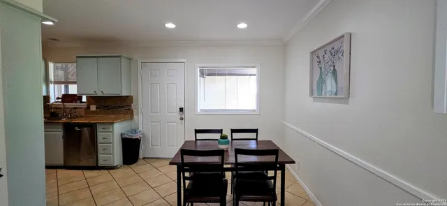 a kitchen with a sink and a stove top oven with wooden floor