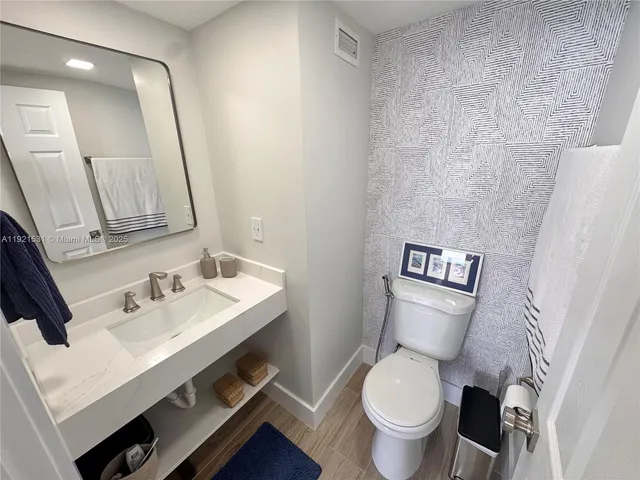 a view of a hallway with two chairs