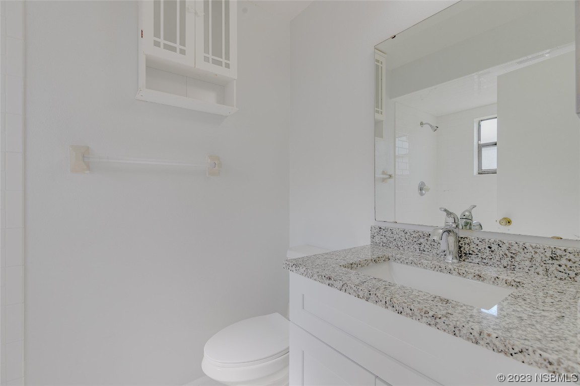 404 Sea Gull Court Edgewater, FL 32141 - Photo 16 of 28 a bathroom with a granite countertop sink and toilet