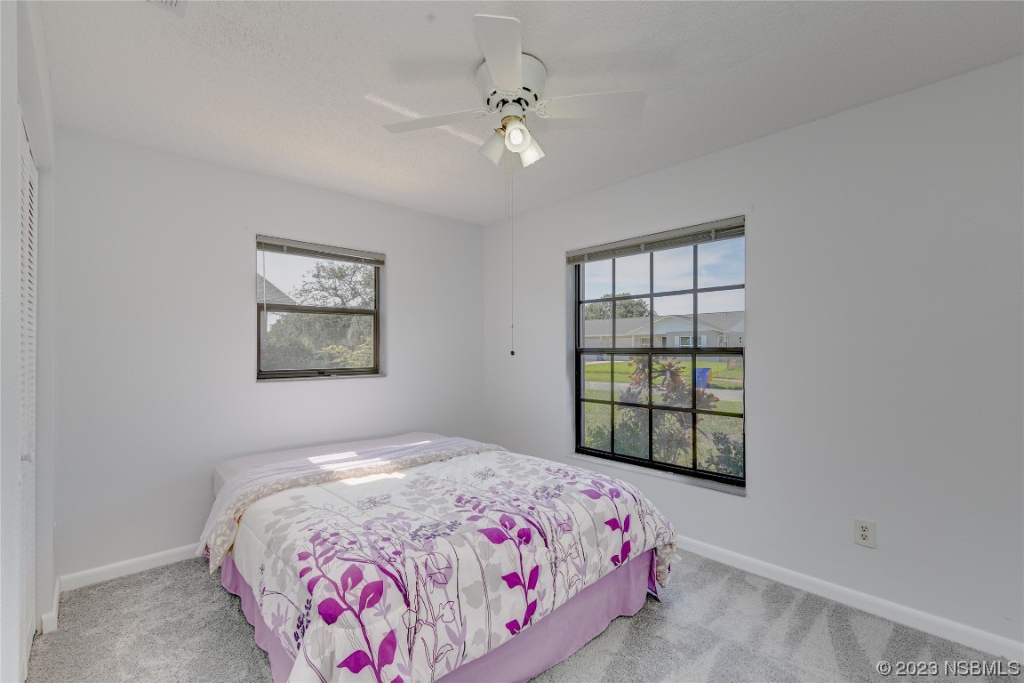 404 Sea Gull Court Edgewater, FL 32141 - Photo 18 of 28 a bedroom with a bed and a window