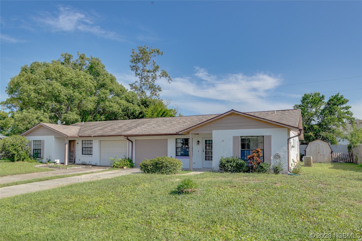 404 Sea Gull Court Edgewater, FL 32141 - Photo 3 of 28 a front view of a house with a yard and garage