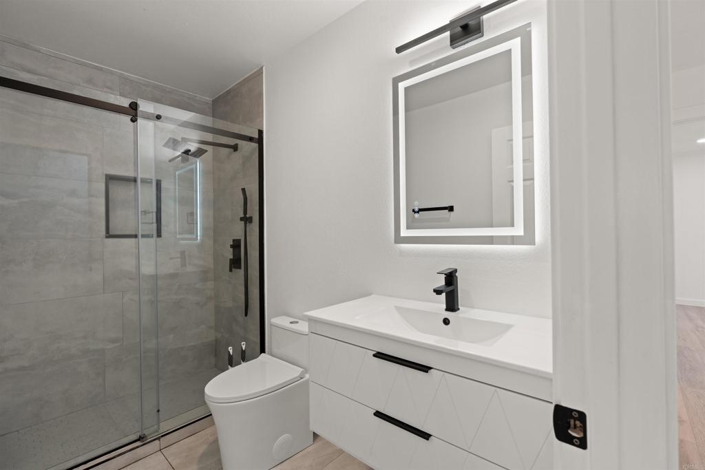 1708 Harold Road Escondido, CA 92026 - Photo 23 of 40 a bathroom with a sink toilet and shower
