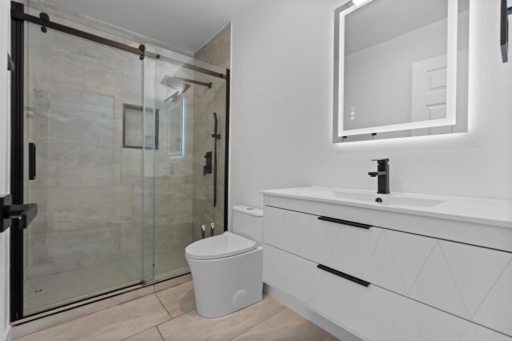 1708 Harold Road Escondido, CA 92026 - Photo 24 of 40 a bathroom with a sink a toilet and shower
