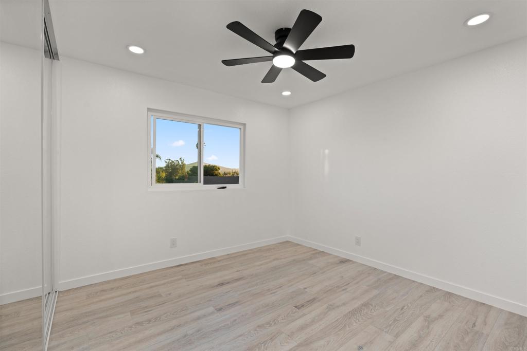 1708 Harold Road Escondido, CA 92026 - Photo 25 of 40 an empty room with wooden floor and windows