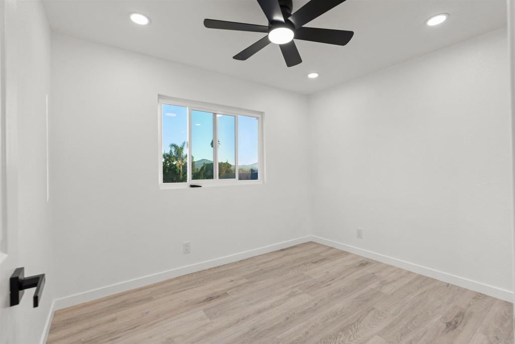 1708 Harold Road Escondido, CA 92026 - Photo 26 of 40 an empty room with a window and a ceiling fan