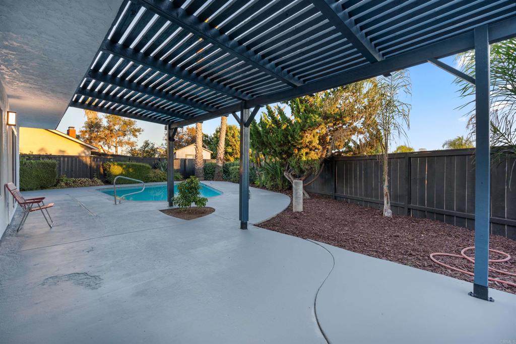 1708 Harold Road Escondido, CA 92026 - Photo 34 of 40 a view of a backyard with table and chairs under an umbrella with a barbeque